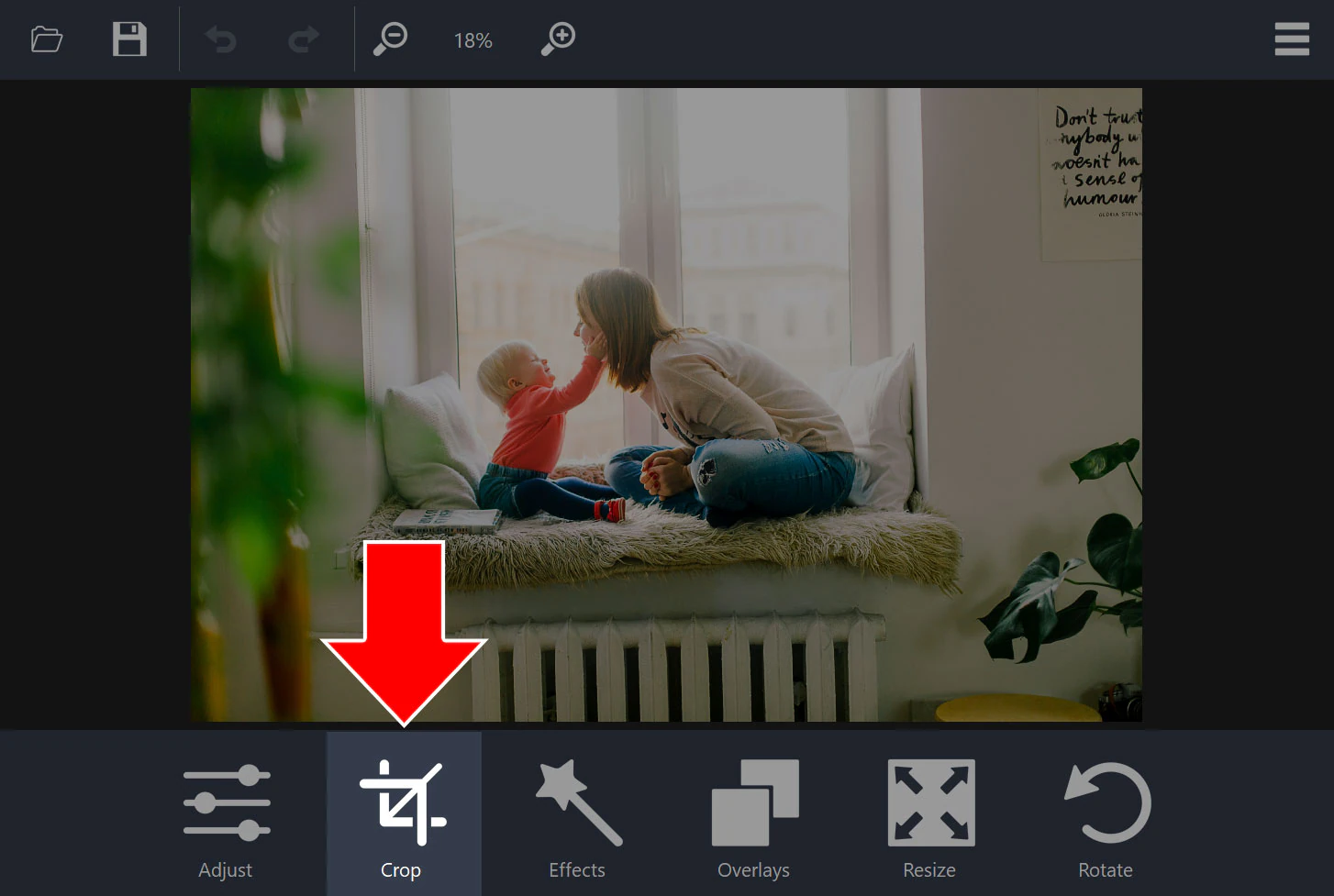 Photo editor with a photo open and an arrow pointing to the Crop button